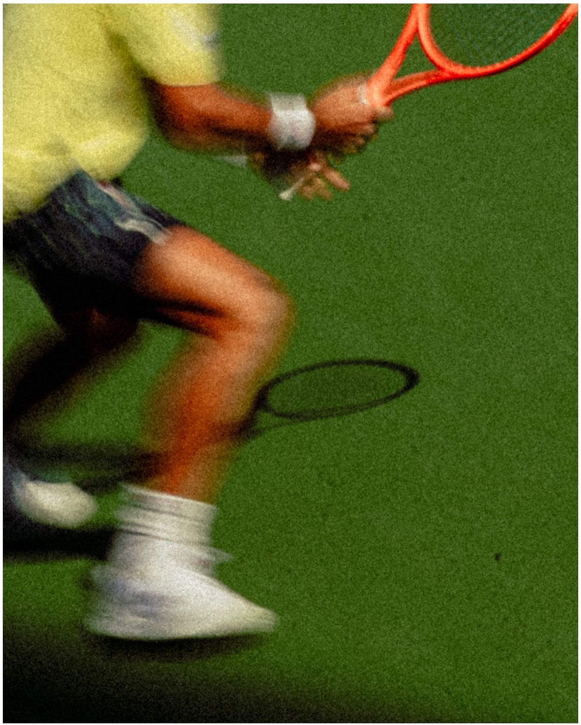 Tennis player mid-rally on a green court